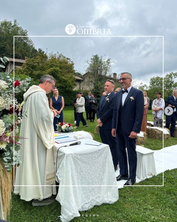 Der Priester steht in vollem Messornat am Volksaltar, vor ihm Bräutigam und Bräutigam im dunkelblauen Anzug, im Halbkreis die Feiergemeinde.